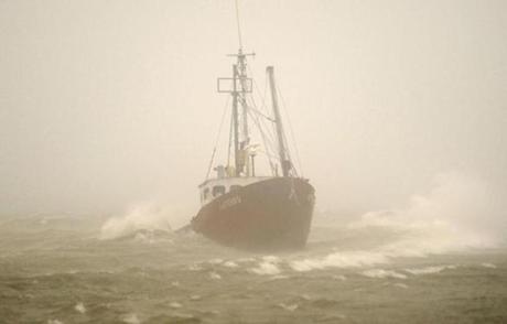The 42-foot fishing vessel, Artemis, rests on the breakwater near the Provincetown Inn.
