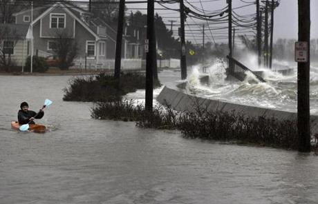 Daniel Cunningham dodged waves on E. Squantum Street in Quincy.
