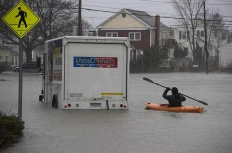 Daniel Cunningham, 22, of Squantum kayaks out to check on a stranded driver.
