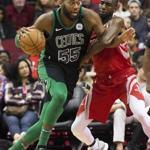Boston Celtics center Greg Monroe (55) is defended by Houston Rockets forward Luc Mbah a Moute (12) during the first half of an NBA basketball game Saturday, March 3, 2018, in Houston. (AP Photo/George Bridges)