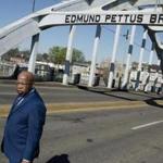 Congressman John Lewis stands on the Edmund Pettus Bridge on Sunday, March 4, 2018, in Selma, Ala., during the annual commemoration of 