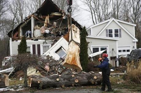 Whitman, MA -- 3/05/2018 - Crews work to remove a tree that fell on a Commercial Street home in Whitman. (Jessica Rinaldi/Globe Staff) Topic: 06stormpic Reporter: 
