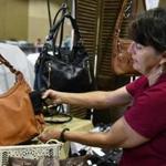 Eve Silverbach sets up her Concealed Carry Purses booth last month during preparations for South Florida Gun Show in Miami. A concealed carry fashion show will be held in Foxborough on March 9. 