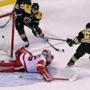 Boston, MA: 3/6/2018: The Bruins Brad Marchand (63) beats Detroit goalie Jimmy Howard in overtime to give Boston a 6-5 victory and himself a hat trick. Torey Krug, who had towo goals himself is at top. The Boston Bruins hosted the Detroit Red Wings in a regular season NHL hockey game at TD Garden. (Jim Davis/Globe Staff)
