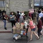 Voters queued outside a polling site at a grocery store in Austin, Texas, on Tuesday for the Texas primary. With so many candidates running, officials expect runoffs for some races. 