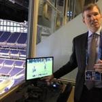 Dr. Allen Sills is the NFL's chief medical officer. Here he points out the monitors the league uses in the press box to watch for players wth concussion symptoms. (Ben Volin/Globe Staff)