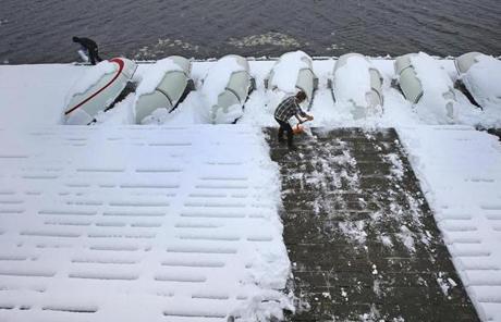 SNOW SLIDER1 CAMBRIDGE, MA - 3/08/2018: Making a path to sailing on the docks at the MIT saililing pavilion in Cambridge on the Charles River. (David L Ryan/Globe Staff ) SECTION: METRO TOPIC 09stormphotos
