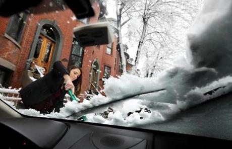 SNOW SLIDER1 Boston, MA - 3/8/18 - On her way to work, Alexandra Rotondo (cq) clears snow and ice from her vehicle, in the South End. More snow than originally expected fell on Boston, in the current Nor'easter. Photo by Pat Greenhouse/Globe Staff Topic: 09storm Reporter: XXX
