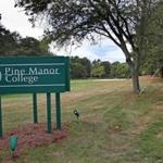 Pine Manor College has been removed from academic probation, the regional accrediting agency said.