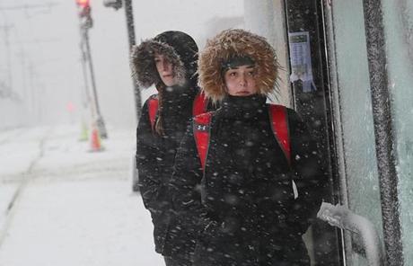 SNOW SLIDER3 Boston, MA., 03/13/18 The third Nor'easter in two weeks arrives in New England and Boston University students, Brooke Jones, left and Samantha Simonetti, right, both BU Dance team memebers, wait in the storm for a train on Commonwealth Avenue for a ride to rehearsal. Suzanne Kreiter/Globe staff
