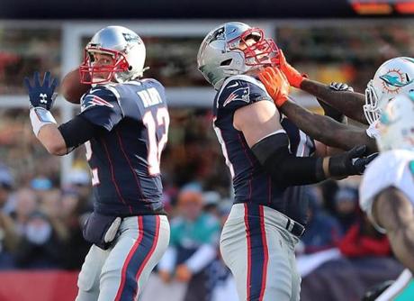 Foxborough MA 11/24/17 New England Patriots Tom Brady looking for a receiver behind teammate Nate Solder against the Miami Dolphins during first half action at Gillette Stadium. (Matthew J. Lee/Globe staff) topic reporter: 
