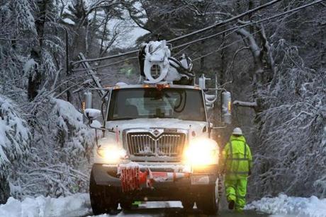 Verizon and Eversource workers assessed a down live power line on School street in Marshfield.
