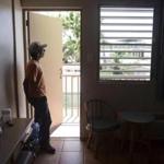 Fernando Muniz looked out from his hotel room, where he has taken refuge for months after Hurricane Maria caused damage to his San Juan residence, in Cabo Rojo.