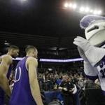 FILE - In this March 18, 2016, file photo, the Holy Cross mascot claps as player leave the court after a first-round men's NCAA college basketball game against Oregon in in Spokane, Wash. The president of the College of the Holy Cross says the Jesuit school will stop using the image of a knight as a logo and mascot even though trustees last month decided to keep the Crusaders athletic nickname. (AP Photo/Young Kwak, File)