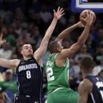Boston Celtics' Al Horford, right, goes up for a shot past Orlando Magic's Mario Hezonja (8) during the first half of an NBA basketball game Friday, March 16, 2018, in Orlando, Fla. (AP Photo/John Raoux)