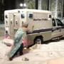 Jason Triplett, dressed in an Elsa costume, pushed a Boston police wagon that was stuck in the snow Tuesday night.