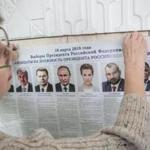 An election worker put up a poster displaying the presidential candidates at a polling station in Crimea on Saturday.