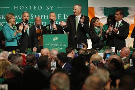 South Boston, MA -- 3/18/2018 - (L-R) Senator Elizabeth Warren sings with Boston City Councilor Michael Flaherty and Congressman Stephen F. Lynch as Governor Baker, Lt. Governor Karyn Polito and Mayor Marty Walsh clap along during the Annual St. Patrick's Day Breakfast at the Ironworkers Local 7 Union Hall. (Jessica Rinaldi/Globe Staff) Topic: 19stpatsbreakfast Reporter: 
