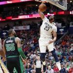 New Orleans Pelicans forward Anthony Davis (23) slam-dunks over Boston Celtics center Greg Monroe (55) in the first half of an NBA basketball game in New Orleans, Sunday, March 18, 2018. (AP Photo/Gerald Herbert)