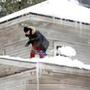 A man cleared snow off his roof in Sudbury last week.