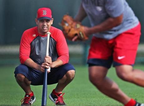 Alex Cora (left) inherits a team that won the AL East title the past two seasons. 

