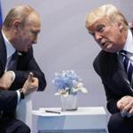 FILE - In this file photo taken on Friday, July 7, 2017, U.S. President Donald Trump, right, meets with Russian President Vladimir Putin at the G-20 Summit in Hamburg, Germany. The Kremlin said Trump called Putin to congratulate him on re-election, and White House press secretary Sarah Huckabee Sanders confirmed that Trump spoke with Putin Tuesday March 20, 2018. (AP Photo/Evan Vucci)