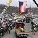 The funeral procession for Daniel Coady wound its way through tow trucks lined up in tribute in North Andover on Wednesday.