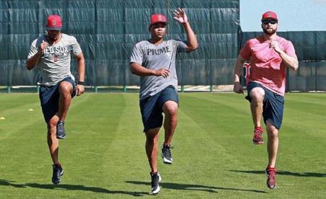 Fort Myers, FL 2/15/2018: Position players, including now veterans Xander Bogaerts (second from left) and Mookie Betts (second from right) get loose together at the start of today's workout. Spring Training for the Red Sox continued today at the Player Development Complex at Jet Blue Park. (Jim Davis/Globe Staff)
