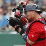 Boston Red Sox catcher Christian Vazquez puts on his mask in the first inning of a spring training baseball game against the Minnesota Twins, Friday, Feb. 23, 2018, in Fort Myers, Fla. (AP Photo/John Minchillo)