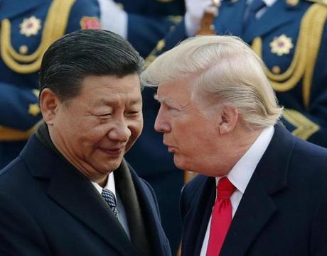 FILE - In this Nov. 9, 2017, file photo, U.S. President Donald Trump, right, chats with Chinese President Xi Jinping during a welcome ceremony at the Great Hall of the People in Beijing. Seeking China?s help on isolating North Korea through economic sanctions, Trump backed off a threat to label China a currency manipulator. He was off-and-on conciliatory on trade during an extended visit to Asia in November, and China announced it would lift restrictions on foreign investment in its banks and other financial institutions. (AP Photo/Andy Wong, File)
