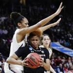 Connecticut's Azura Stevens (23) defends South Carolina's Lele Grissett (24) during the first half of a regional final at the a women's NCAA college basketball tournament Monday, March 26, 2018, in Albany, N.Y. (AP Photo/Frank Franklin II)