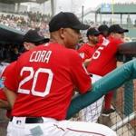 Boston Red Sox manager Alex Cora (20) watches his players from the dugout in the first inning of a spring training baseball game against the Minnesota Twins, Friday, Feb. 23, 2018, in Fort Myers, Fla. (AP Photo/John Minchillo)