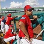Boston Red Sox manager Alex Cora stands in the dugout in the fourth inning of a spring training baseball game against the Tampa Bay Rays, Saturday, Feb. 24, 2018, in Fort Myers, Fla. (AP Photo/John Minchillo)