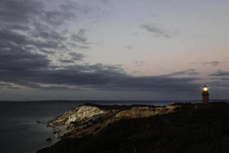 Gay Head Light flashes a white signal in Aquinnah, MA, Oct. 13, 2013 on the island of Martha's Vineyard. The lighthouse flashes alternating red and white beams of light. (AP Photo/Mark Lennihan)
