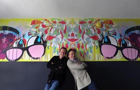 Stephen Davis, left, and Robin Alexander Brown are co-developers of a hotel called Studio Allston. They were photographed in one of the rooms with art by Thomas Buildmore.
