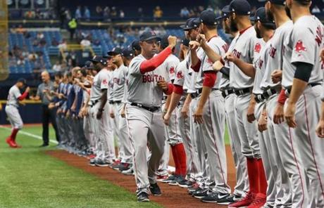 St. Petersburg, FL: 3/29/2018: Red Sox manager Alex Cora runs the gauntlet during pre game introductions. The Boston Red Sox visited the Tampa Bay Rays for the Opening Day of the 2018 baseball season at Tropicana Field. (Jim Davis/Globe Staff)
