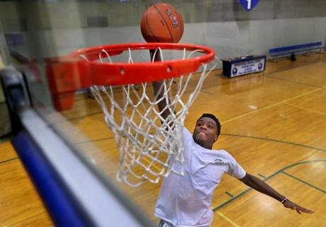 Foxborough- 03/30/18 Mansfield High School's Damani Scott slam-dunks the ball at Premier Courts. Photo by John Tlumacki/Globe Staff(sports)
