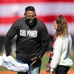 Boston-04/05/18 The Boston Red Sox vs Rays Home opener- David Ortiz takes his Red Sox jersey off to reveal his t-shirt to Olympian Aly Raisman during a pregame ceremony where they both announced, 
