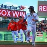 Boston, MA: 4/5/2018: The Red Sox Hanley Ramirez won the game for Boston with a bottom of the twelfth inning bases loaded walk off single, as the home team won3-2. He is pictured getting chased by jubilant teammates after his hit. The Boston Red Sox hosted the Tampa Bay Rays in their 2018 MLB home Opening Day baseball game at Fenway Park. (Jim Davis/Globe Staff)