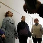 Reverend Liza Neal (second from left) lead a prayer in the hallway with other faith leaders who came in support of a Peruvian immigrant facing deportation and taking sanctuary inside South Congregational Church City as inspectors and fire officials search the apartment she and her family are staying in. 