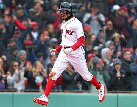 Boston, MA: 4/8/2018: The Red Sox Mookie Betts is walking on air as he scores Boston's sixth run of the bottom of the eighth inning on a double by teammate Andrew Benintendi. The run gave the Red Sox an 8-7 lead, which would be the final score. The Boston Red Sox hosted the Tampa Bay Rays in a regular season baseball game at Fenway Park. (Jim Davis/Globe Staff)
