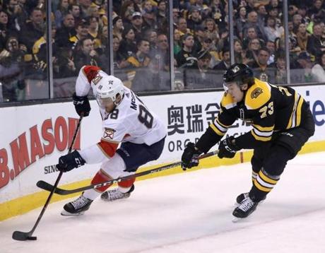 Boston MA 4/5/18 Boston Bruins defenseman Charlie McAvoy (73) putting definsive pressure on Florida Panthers left wing Jamie McGinn (88) during first period action at the TD Garden. (photo by Matthew J. Lee/Globe staff) topic: reporter: 
