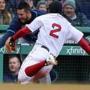 Boston, MA: 4/8/2018: Red Sox SS Xander Bogaerts (2) slides towards the Tampa Bay dugout as he chases an errant seventh inning throw. He was injured on the play and had to leave the game. The Boston Red Sox hosted the Tampa Bay Rays in a regular season baseball game at Fenway Park. (Jim Davis/Globe Staff)