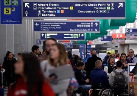 Passengers walk in Terminal 3 at O'Hare Airport in Chicago. The Airline Quality Rating study released Monday found that US airlines are losing fewer bags and complaints are down.
