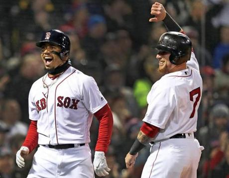 Boston, MA: 4/9/2018: The Red Sox Mookie Betts and Chrstian Vazquez rejoice after they both scored on a bottom of the second inning hit by Andrew Benintendi. The Boston Red Sox hosted the New York Yankees in a regular season MLB baseball game at Fenway Park. (Jim Davis/Globe Staff)
