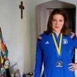 Brighton, MA -- 4/08/2018 - Christine Yost, 35, of Brighton poses for a portrait with her Boston Marathon medal at her apartment in Brighton. (Jessica Rinaldi/Globe Staff) Topic: Marathon Reporter: 