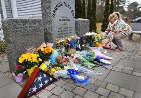Pennie MacDonald from Mashie placed flowers in front of the Yarmouth police memorial next to the police station.
