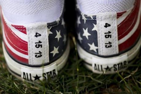 Boston, MA - 7/4/17 - Ritajayne Rivera, with American themed sneakers with the date of the Boston Marathon bombing written on them during the Fourth of July Pops celebration on the Esplanade on Tuesday, July 4, 2017. Rivera was near the first bomb during marathon. (Nicholas Pfosi for The Boston Globe) Topic: 05IndepenceDaypic
