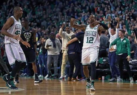 Boston, MA: 4/15/18: The Celtics Terry Rozier III, (right) made the crowd come out of their seats after he hit a three pointer with .5 seconds left in the fourth quarter to give Boston a 99-96 lead. Teammate Al Horford is at left. The Boston Celtics hosted the Milwaukee Bucks in Game One of an Eastern Conference First Round NBA Playoff basketball game at the TD Garden. (Jim Davis/Globe Staff)
