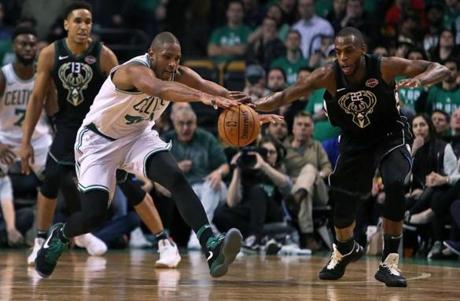 Boston, MA: 4/15/18: The Celtics Al Horford beats the Bucks Khris Middleton to a late fourth quarter loose ball. The Boston Celtics hosted the Milwaukee Bucks in Game One of an Eastern Conference First Round NBA Playoff basketball game at the TD Garden. (Jim Davis/Globe Staff)
